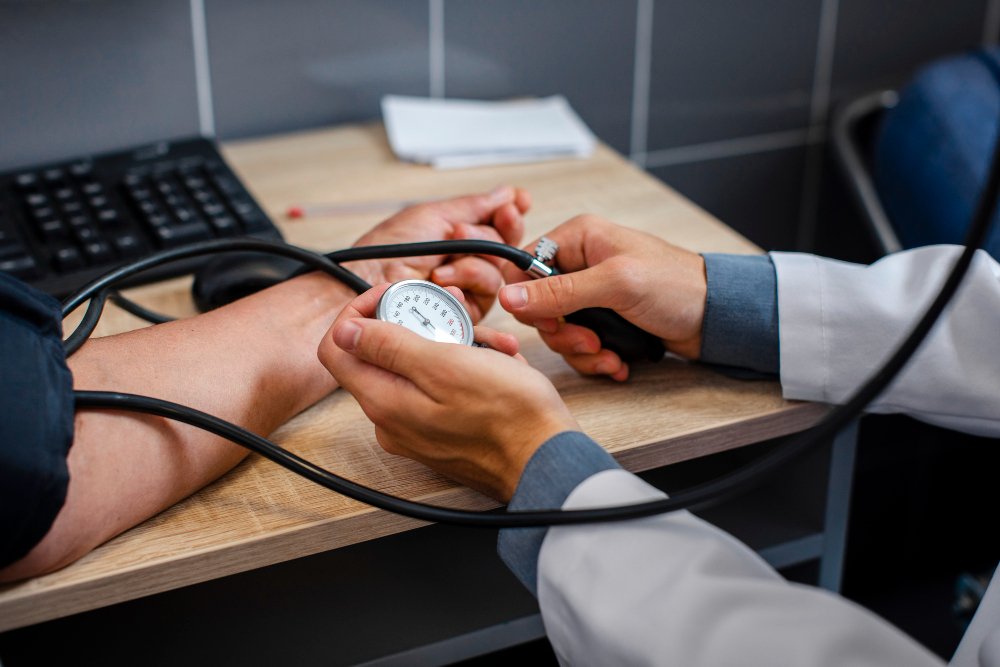 A medical professional checking blood pressure using a manual blood pressure monitor