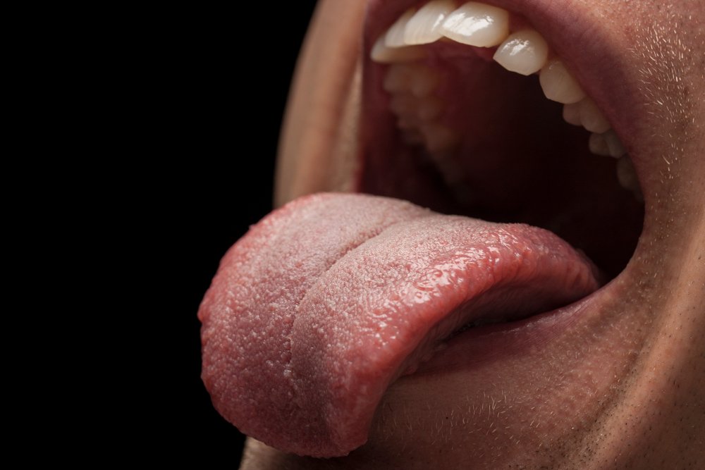 A person protruding their tongue from their mouth