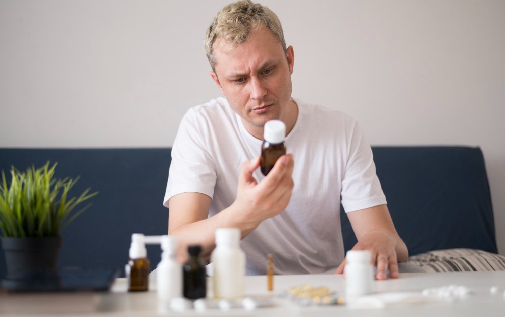 A person looking at a syrup medication bottle